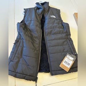 The North Face woman’s vest reverses to a Black soft fleece in size medium